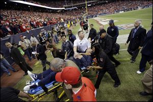 Houston Texans coach Gary Kubiak is taken off the field on a stretcher at halftime Sunday in Houston.