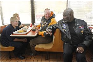 Mayor Mike Bell turns to speak with Rudy's Hot Dog customer Doug Whiting, who was eating there with his sons on the day before Toledo's mayoral election.