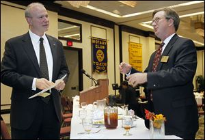 Roger Wood, president and CEO of Dana Holding Corp., left, speaks with Keith Burwell of the Rotary Community Foundation, after the Toledo Rotary Club  meeting at the Park Inn hotel downtown. 