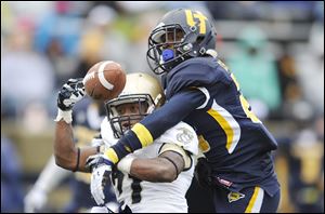 Toledo freshman DeJuan Rogers, right, breaks up a pass intended for Navy’s DeBrandon Sanders earlier this season.