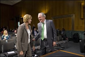 Senate Health, Education, Labor, and Pensions Committee Chairman Sen. Tom Harkin, D-Iowa, greets Medicare chief Marilyn Tavenner at hearing. 