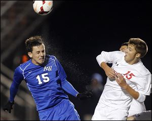 Anthony Wayne's Philip Reed heads the ball against Mentor's Ryan Brass in a Division I state semifinal.