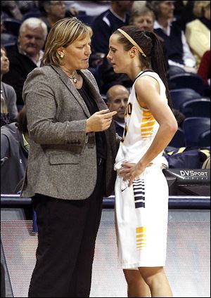 At left, UT coach Tricia Cullop talks with Stephanie Recker during an exhibition game last week at Savage Arena. At right, UT athletic director Mike O’Brien listens as Cullop speaks at her introduction on April 18, 2008. She owns a 125-44 record with the Rockets.