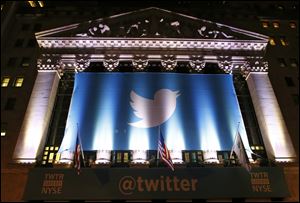 A banner adorns the facade of the New York Stock Exchange in advance of Twiiter's initial public offering today.