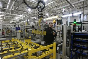 A photo of an employee at the General Motors Toledo Transmission plant in Toledo. A Brookings Institution study noted that Toledo has developed links to Canadian and Mexican cities largely through auto parts, but also with energy products.