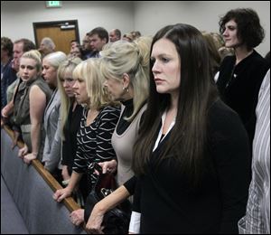 Alexis Somers, right, her sister Rachel MacNeill, upper right, and family members rise for the jury to take their place for closing arguments on the final day of the murder trial Friday for Martin MacNeill in Provo, Utah.