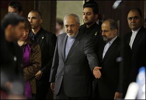 Catherine Ashton, the European Union's foreign policy chief, second from left, and Iranian Foreign Minister Mohammad Javad Zarif, center, arrive at a press conference at the end of the Iranian nuclear talks today in Geneva.