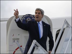 U.S. Secretary of State John Kerry steps aboard his aircraft today in Geneva, Switzerland.