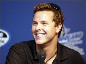 Trevor Bayne, the 2011 Daytona 500 winner, smiles as he listens to questions during a news conference in June, 2011.