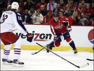 Washington Capitals right wing Alex Ovechkin (8), from Russia, looks to shoot with Columbus Blue Jackets left wing R.J. Umberger (18), nearby, in the first period.