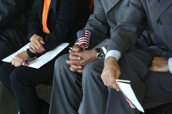 citizens13-New-citizens-hold-American-flags
