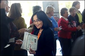 Teresita Castillo-Badman smiles after she received her documen-tation of citizenship.