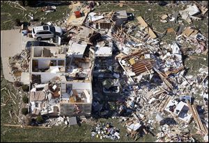 This aerial photo taken Monday shows a home that was destroyed by an EF-4 tornado that hit the town of Washington, Ill.