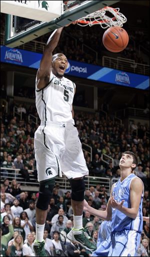 Michigan State's Adreian Payne dunks over Columbia's Luke Petrasek on Friday in East Lansing, Mich.