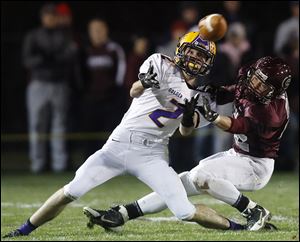 Bryan’s Sean Culler makes a catch in front of Genoa’s Nick Wolfe. Culler has 27 catches for 561 yards and six touchdowns.