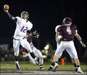 Bryan quarterback Austin Schimmoeller throws over the Genoa defense during a Division IV playoff game on Nov. 8 in Genoa. He’s thrown for 2,511 yards and 33 touch­downs this season.