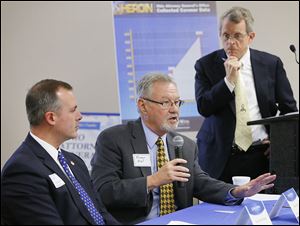 Dr. Orman Hall, director of Gov. John Kasich's Healthy Ohio office, speaks as Ohio Attorney General Mike DeWine, right, and state Rep. Robert Sprague listen during a forum at the Emergency Services Training Center on Jefferson in downtown Toledo.