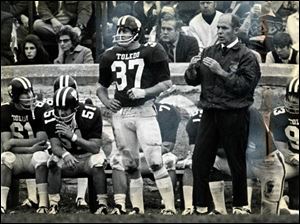 University of Toledo football coach Frank Lauterbur jumps to his feet to call timeout from the sidelines October 31, 1970.    