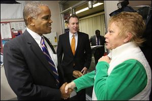 Lt. Gov. candidate Eric Kearney of Cincinnati, left, greets Sandy Smith as he and Democratic gubernatorial candidate Ed FitzGerald, center, enter Lucas County Democratic Party headquarters on Madison Avenue in Toledo. 