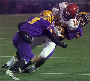 Bryan's Lucas Nye (9) and Derek Knisely take down Kenton's Luke Jackson (14) in the second quarter of Friday's Division IV regional final match up against Kenton at Donnell Stadium in Findlay. Bryan lost, 46-43.