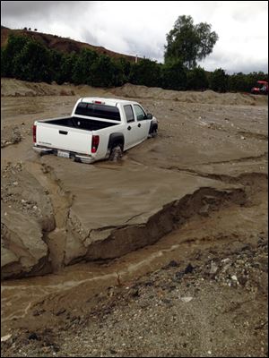 Flooding, mud and debris strike San Timoteo Canyon Road in Redlands, Calif. Firefighters responded to dozens of calls of weather-related traffic collisions, flooding and mudslides spurred by Thursday's downpour in southern California. 