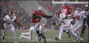Ohio State QB Braxton Miller (5) runs the ball against Indiana safety Mark Murphy (37) during the first quarter.