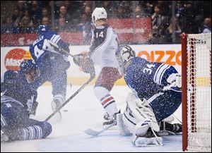 Toronto Maple Leafs goalie James Reimer is covered in spray after clearing the puck against the Columbus Blue Jackets during the first period.