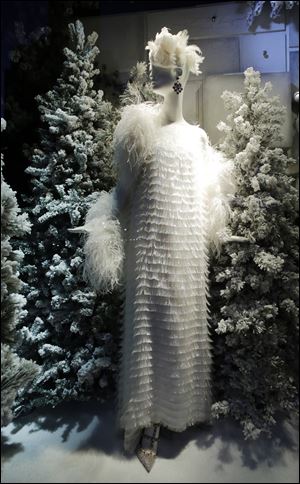 A holiday window at Bergdorf Goodman in New York features a snowy fashion scene.