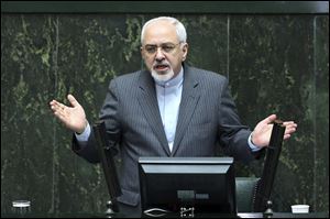 Iranian Foreign Minister Mohammad Javad Zarif speaks in the parliament in Tehran, Iran today. He and President Rouhani must convince skeptics that they are not compromising on key issues of national sovereignty.