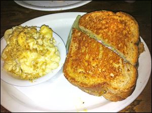 The Cuban sandwich with Smoked Gouda Mac -N-Cheese with Bacon and Tomato at Ye Olde Durty Bird