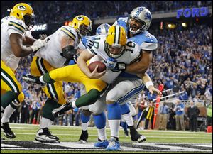 Detroit Lions defensive tackle Ndamukong Suh (90) sacks Green Bay Packers quarterback Matt Flynn for a safety during the third quarter of an NFL football game at Ford Field in Detroit, Thursday, Nov. 28, 2013. (AP Photo/Paul Sancya)