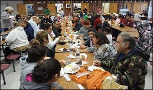 Evacuees eat Thanksgiving dinner at Willard High School.