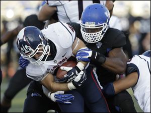 Buffalo linebacker Khalil Mack, right, tackles Connecticut running back Max DeLorenzo (44) during a game in Buffalo, N.Y. in September. Mack is the leader of a Buffalo defense that allows just 22.2 points per game, second only to the Falcons (14.4). 