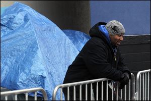 Bryan Davis awaits Black Friday deals at Best Buy with a smile.