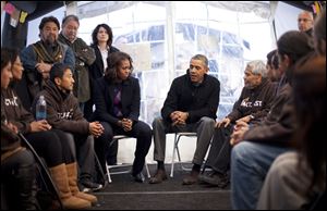 President Obama and first lady Michelle Obama visit with individuals who are taking part in Fast for Families on the National Mall in Washington.