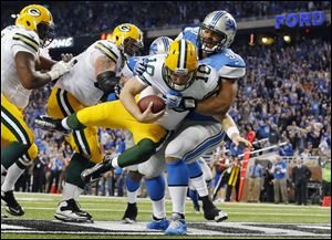 Detroit Lions defensive tackle Ndamukong Suh (90) sacks Green Bay Packers quarterback Matt Flynn for a safety during the third quarter Thursday.