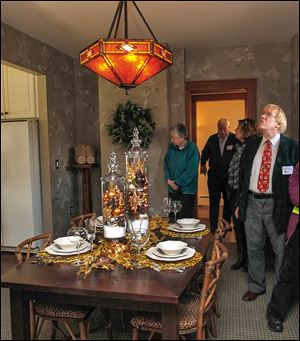 Bill Frisk, right, looks around the dining room at the 2702 Parkwood Ave. The home was built in 1916 for a mechanical engineer named George Smedley.