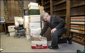 Dave Mittelstaedt packs up books in his office at the Spitzer Building. He practiced law there for 30 years and valued having other lawyers nearby if he had questions.