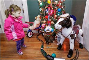 Rhea Ellis-Boone, 2, of Toledo is drawn to a children’s display at Mansion View Inn, 2035 Collingwood Blvd.