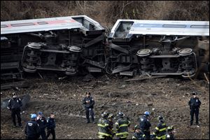 Emergency personnel respond to the scene of a Metro-North passenger train derailment in the Bronx borough of New York Sunday.