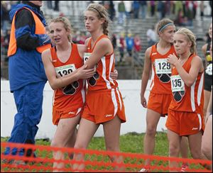 Liberty Center’s Emma Babcock, left, Rachael Pinson, Brittany Atkinson, and Jenna Vollmar leave the course after winning the Division III state championship.