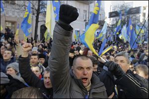 Protesters chant slogans outside the Parliament in Kiev, Ukraine. The opposition on Tuesday sought a vote of no confidence in the government that failed. Secretary of State John Kerry called off a visit to the country scheduled for this week.