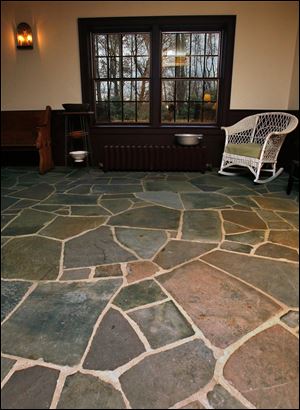A floor made of flagstones that were originally used for the sidewalks in the city of Ravenna, Ohio, is in the entry parlor of the home designed and built by Nancy Angerman and her husband, Tom Hutter.