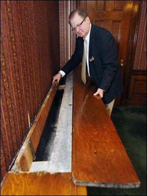 Roger Parker, general manager of the Toledo Club, shows the hideaway used to stash liquor during Prohibition. At the time, the club’s business center was known as St. Andrew’s Room.