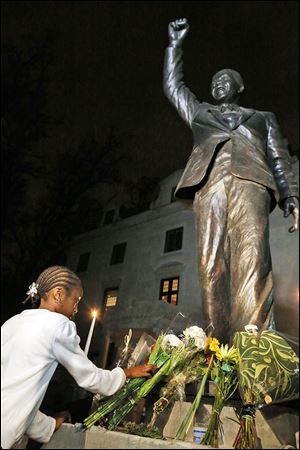 Flowers are placed at a statue of Nelson Mandela at South Africa’s U.S. embassy. Participants in his 1990 Detroit appearance remember the excitement.