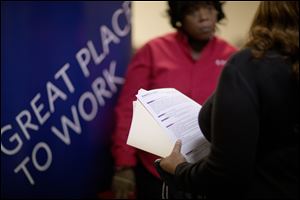  Jimmetta Smith, of Lithonia, Ga., right, the wife of a U.S. Marine veteran, holds her resume while talking with Rhonda Knight, a senior recruiter for Delta airlines, at a job fair for veterans and family members in Marietta, Ga. last month.