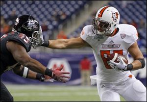 Bowling Green State University player Alex Bayer (82) gets a hand in the face of Northern Illinois University player Boomer Mays (45) during the second quarter.
