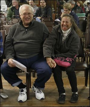 Jim Klein of Adrian is kept from raising his hand to bid on more items by his wife, Zelda Klein. The items sold in the auction on Sunday were from the estate of Mildred ‘Millie’ Benson’s daughter, Margaret ‘Peggy’ Wirt, who died in January.