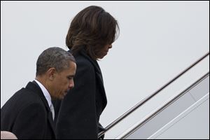 President Obama and first lady Michelle Obama board Air Force One to travel to South Africa for a memorial service in honor of Nelson Mandela today in Andrews Air Force Base, Md. (AP Photo/ Evan Vucci)   