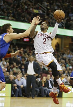 Cleveland Cavaliers' Kyrie Irving (2) shoots against New York Knicks' Andrea Bargnani.